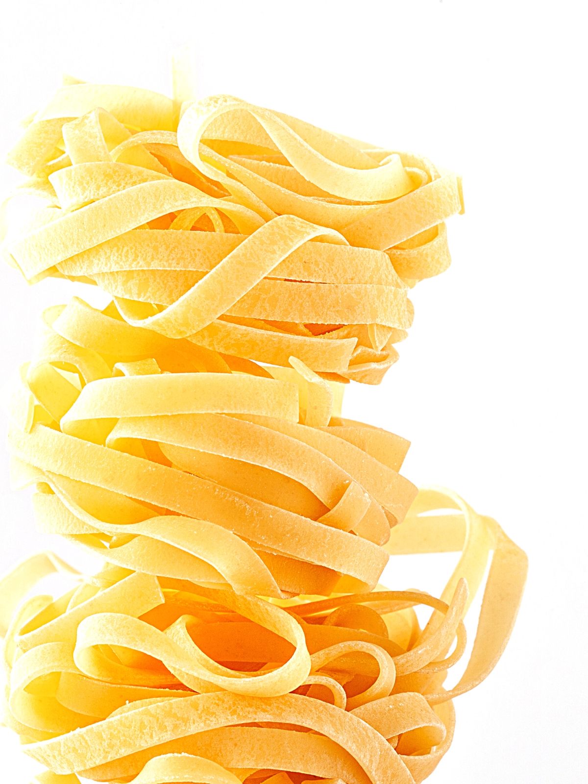 Stacked Fettuccine on a white background.