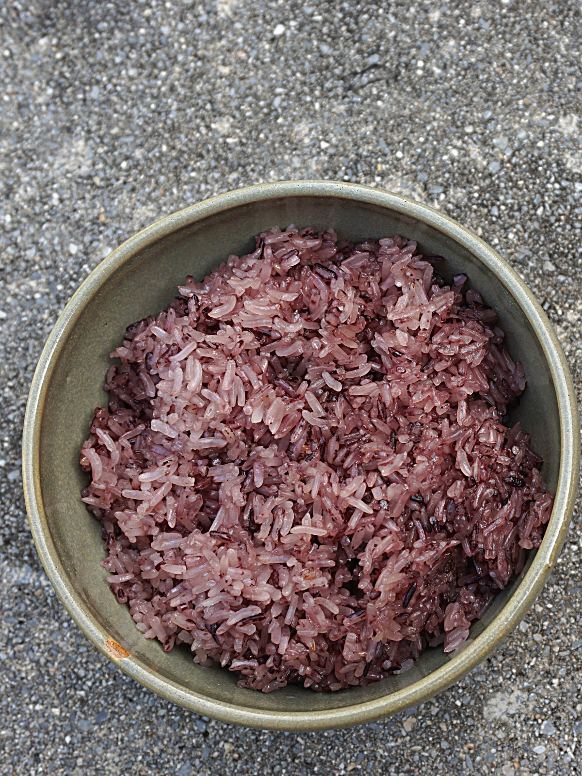 A bowl of cooked black sticky rice.