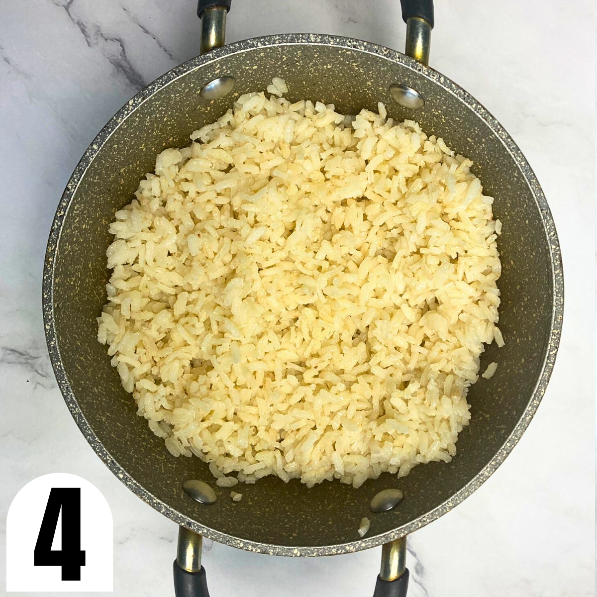 Cooked Arborio rice in a grey saucepan.