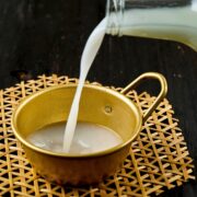 Homemade rice wine powered into a metal cup.