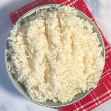 Grey bowl filled with cooked white basmati rice.