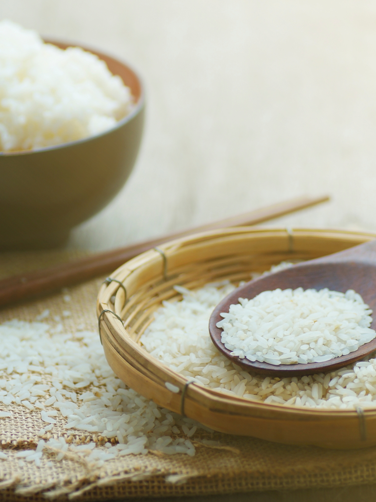 Long sticky rice with boiled sticky rice in a bowl in the background.