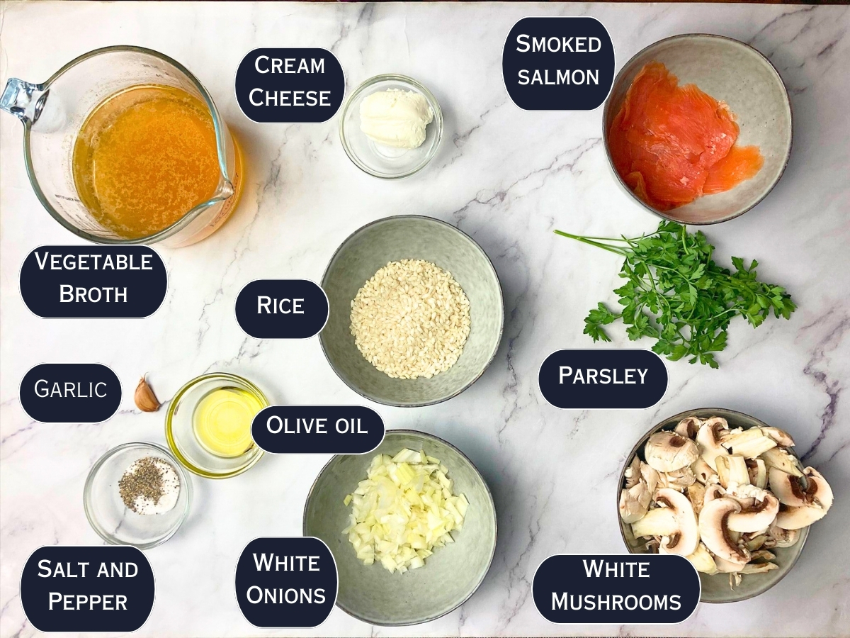 Mushroom and salmon risotto ingredients on a marble countertop.