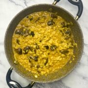 Saffron and mushroom risotto in a saucepan.