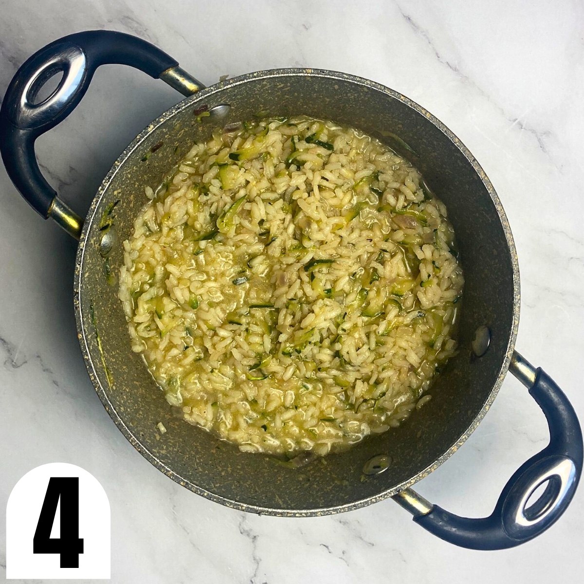 Grated zucchini risotto in a saucepan.
