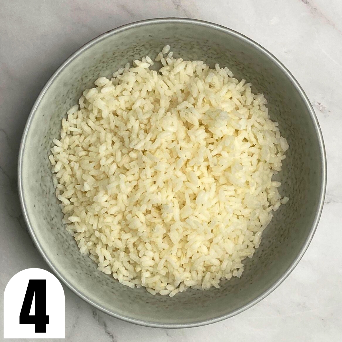 Grey bowl filled with boiled Carnaroli rice.
