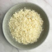 Grey bowl filled with boiled Carnaroli rice.