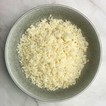 Grey bowl filled with boiled Carnaroli rice.