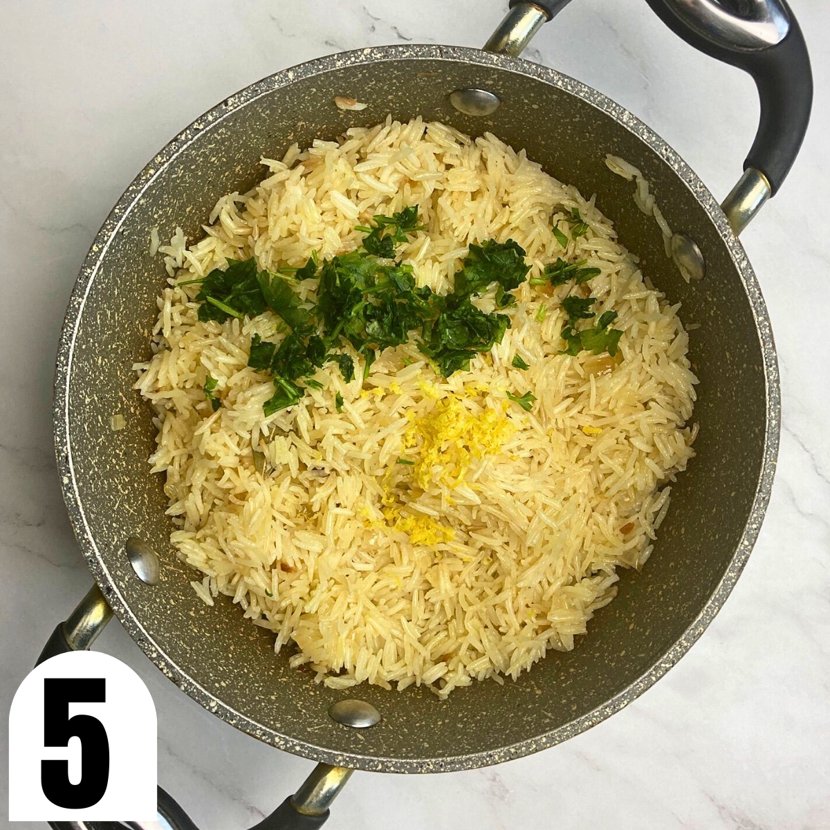 Lemon rice pilaf in stone saucepan with parsley on top.