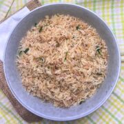 Bowl of herbed rice pilaf on top of a tea towel.