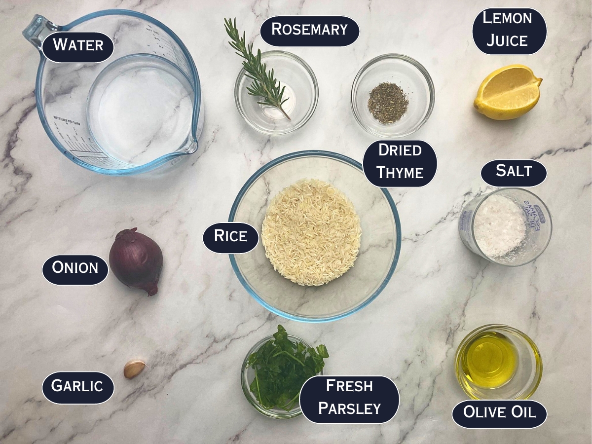 Herbed rice pilaf ingredients displayed on a marble countertop.