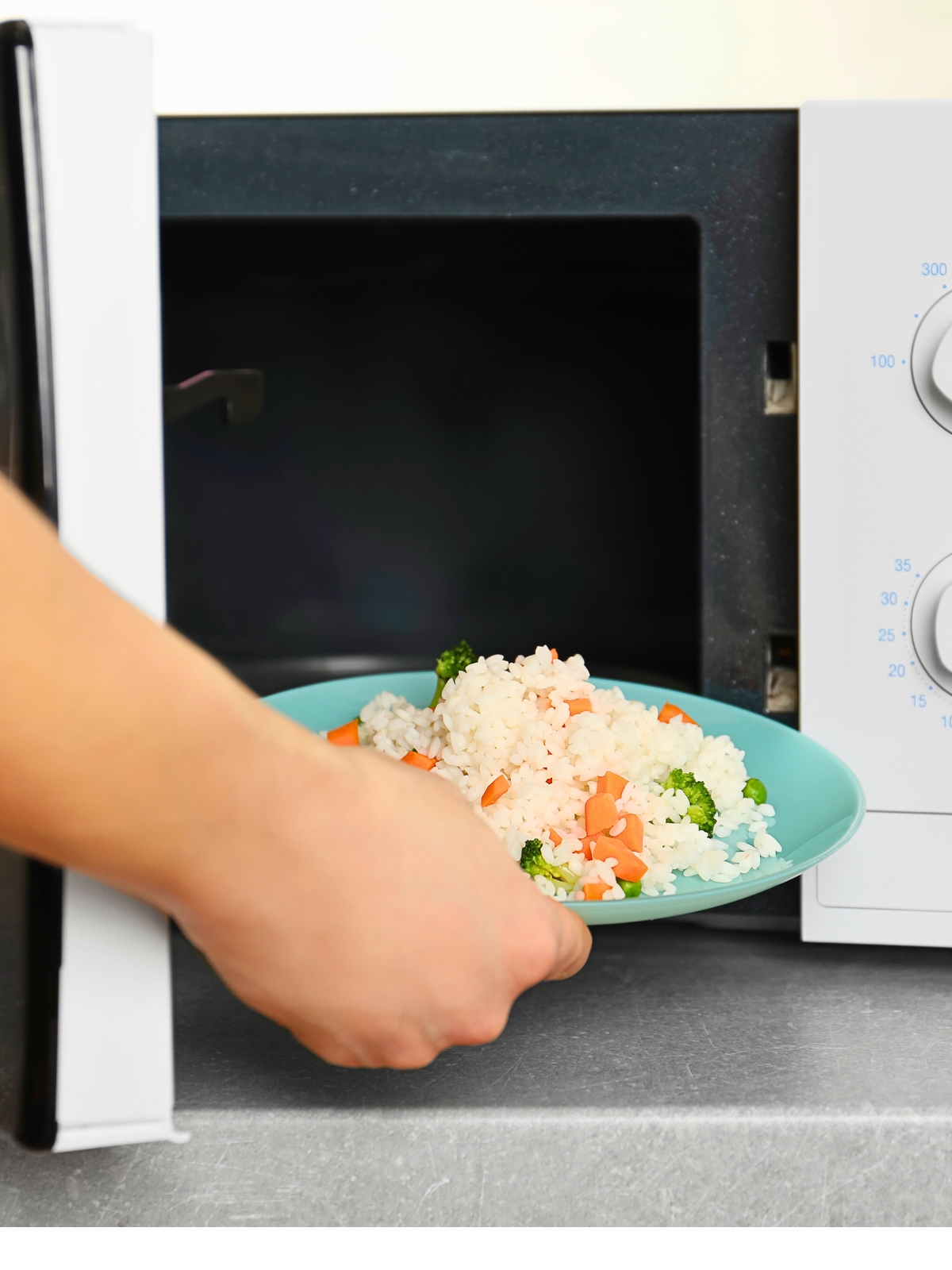 A Person Heating a Plate of Rice in the Microwave.