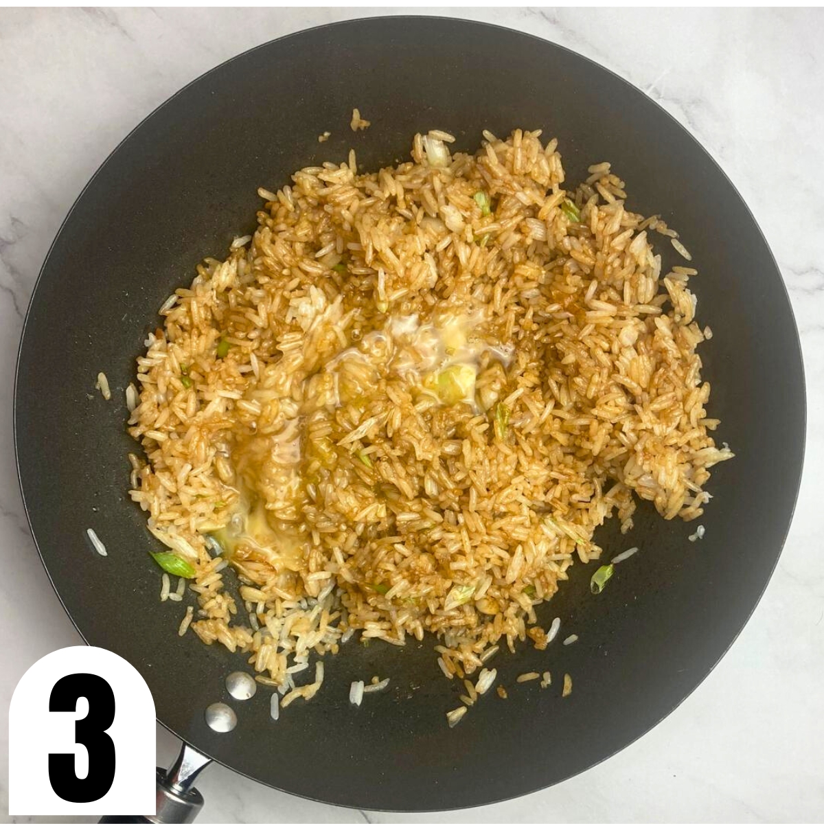 Wok with soy fried rice with beaten egg.