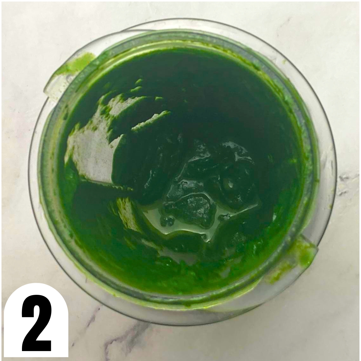 Blender with pureed spinach.