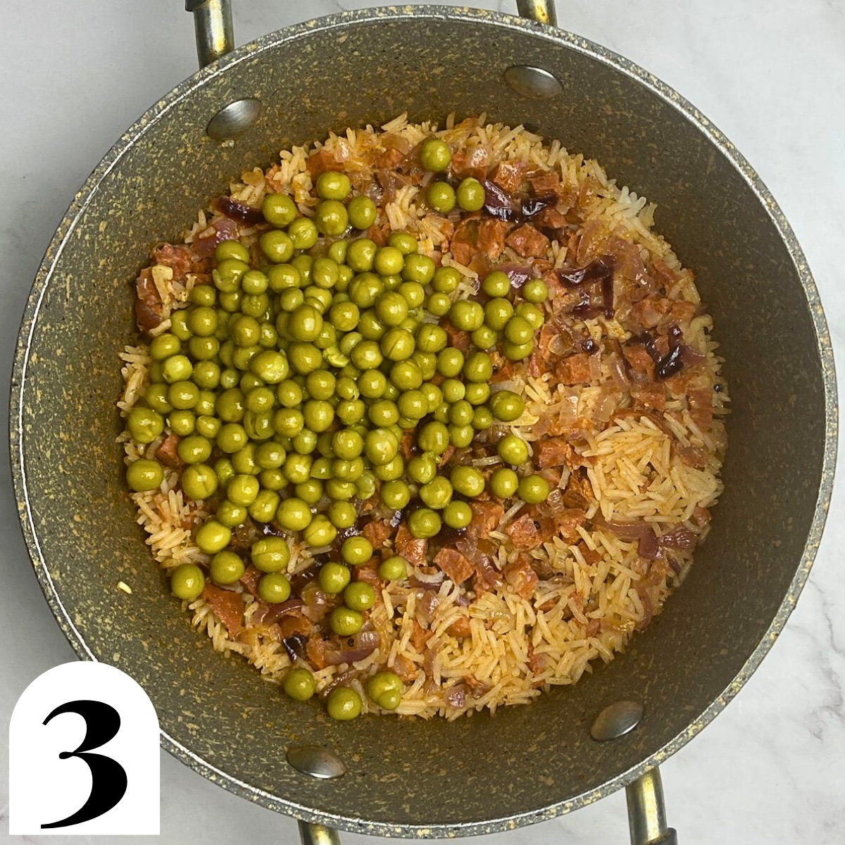 Grey pan with rice, peas and chorizo.