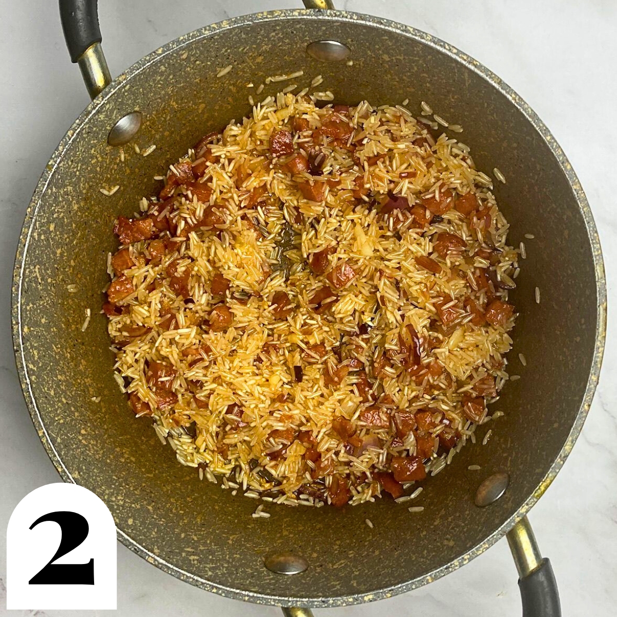Pan with rice and chorizo in it.